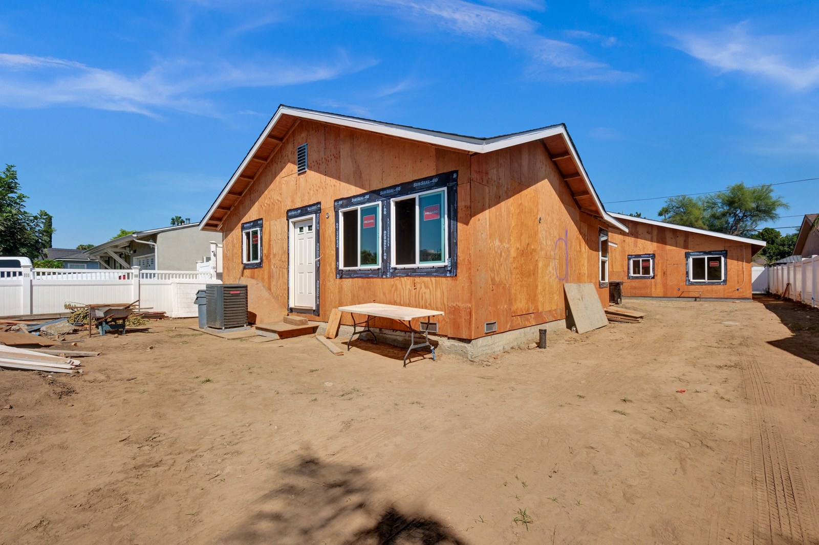 SB9 multi-unit homes under construction with exterior sheathing and windows installed