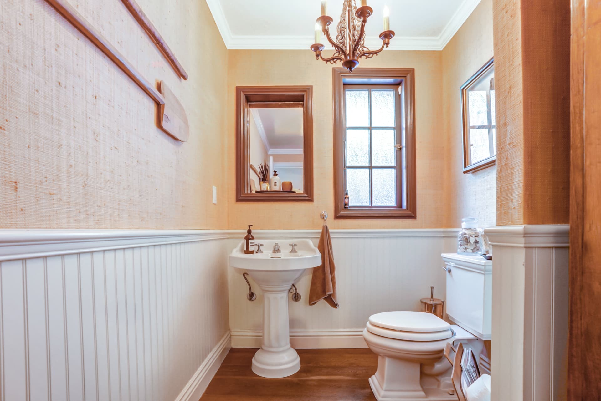 Hancock Park powder room with pedestal sink and vintage chandelier