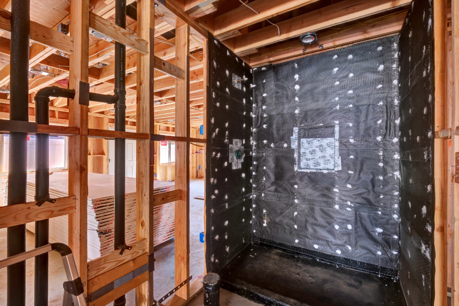 Bathroom framing, plumbing rough-in, and waterproofing during construction