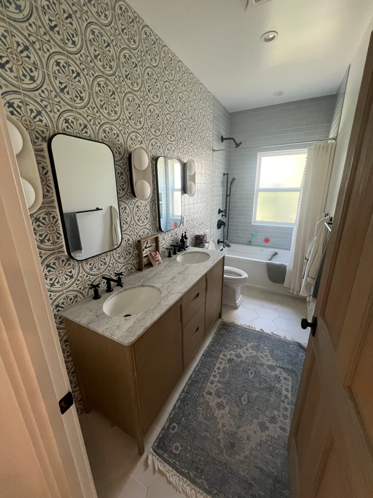 Pacific Palisades bathroom with patterned tile wall and double vanity