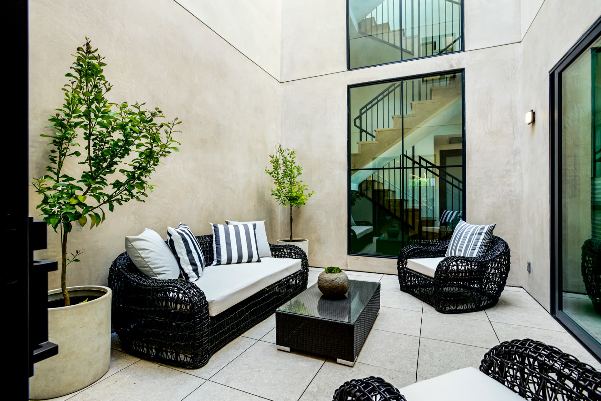 Los Angeles private courtyard with woven seating and staircase views