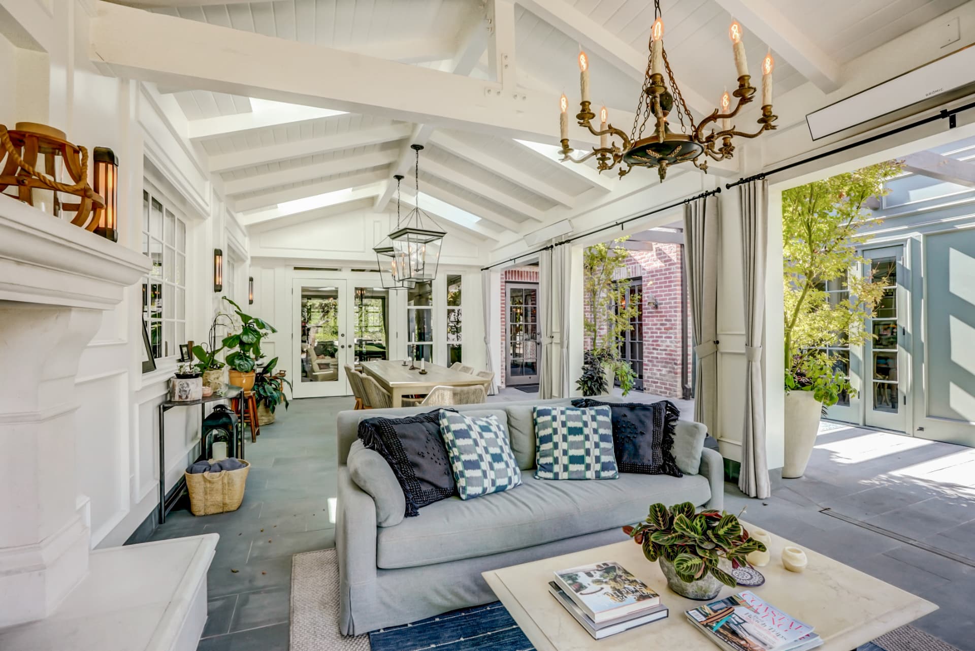 Hancock Park covered garden room with chandelier and indoor-outdoor seating
