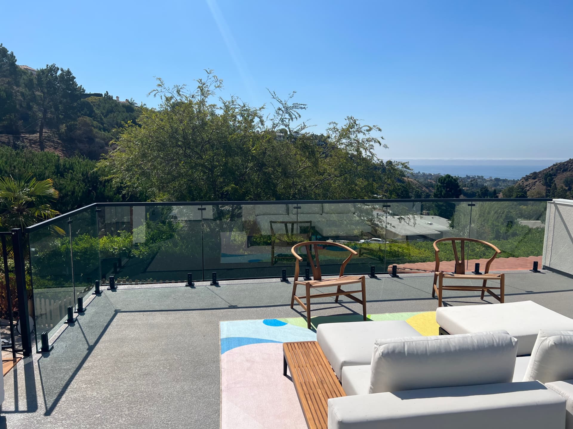 Pacific Palisades rooftop terrace with glass railing and ocean view
