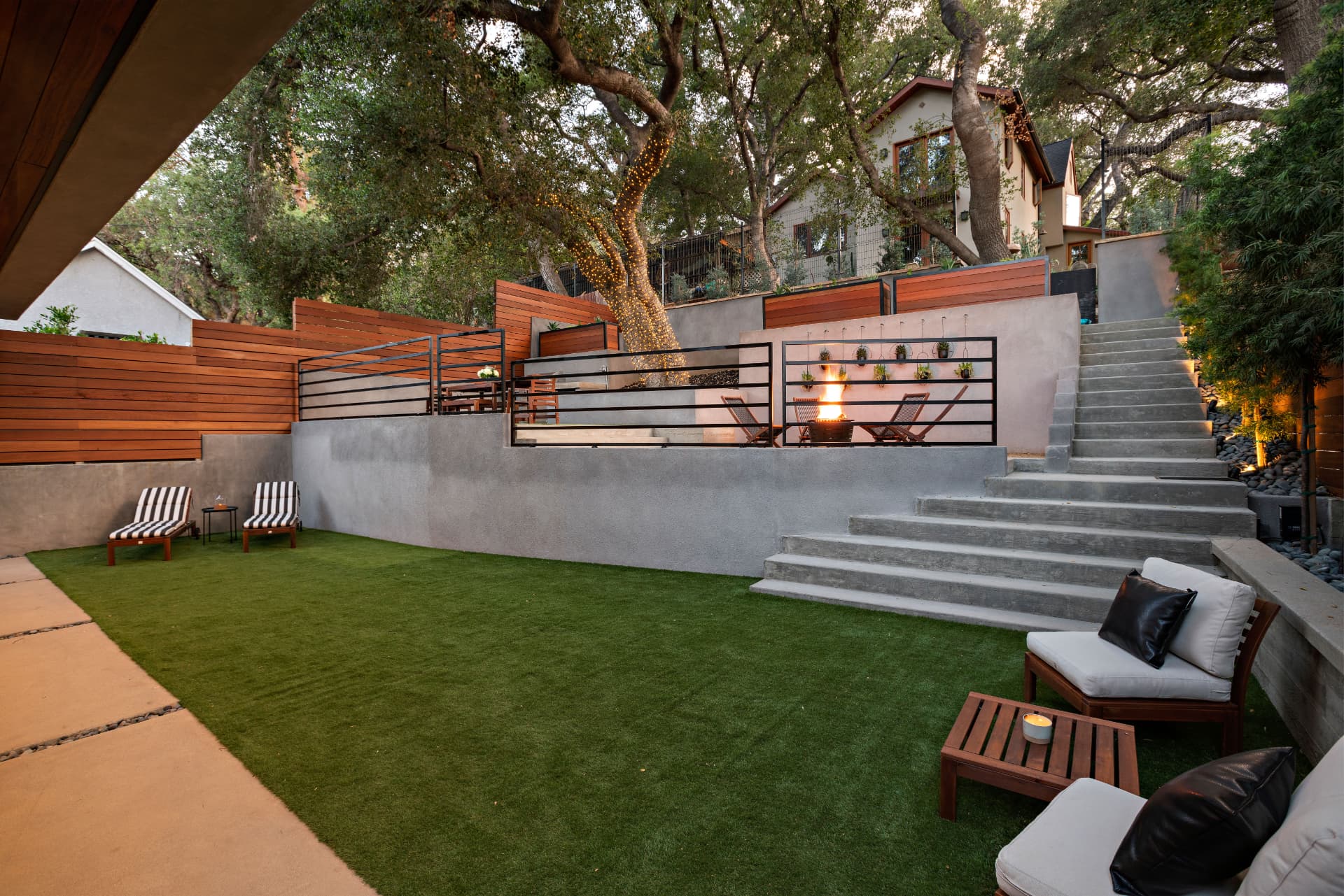 Woodland Hills terraced backyard with fire pit and concrete steps