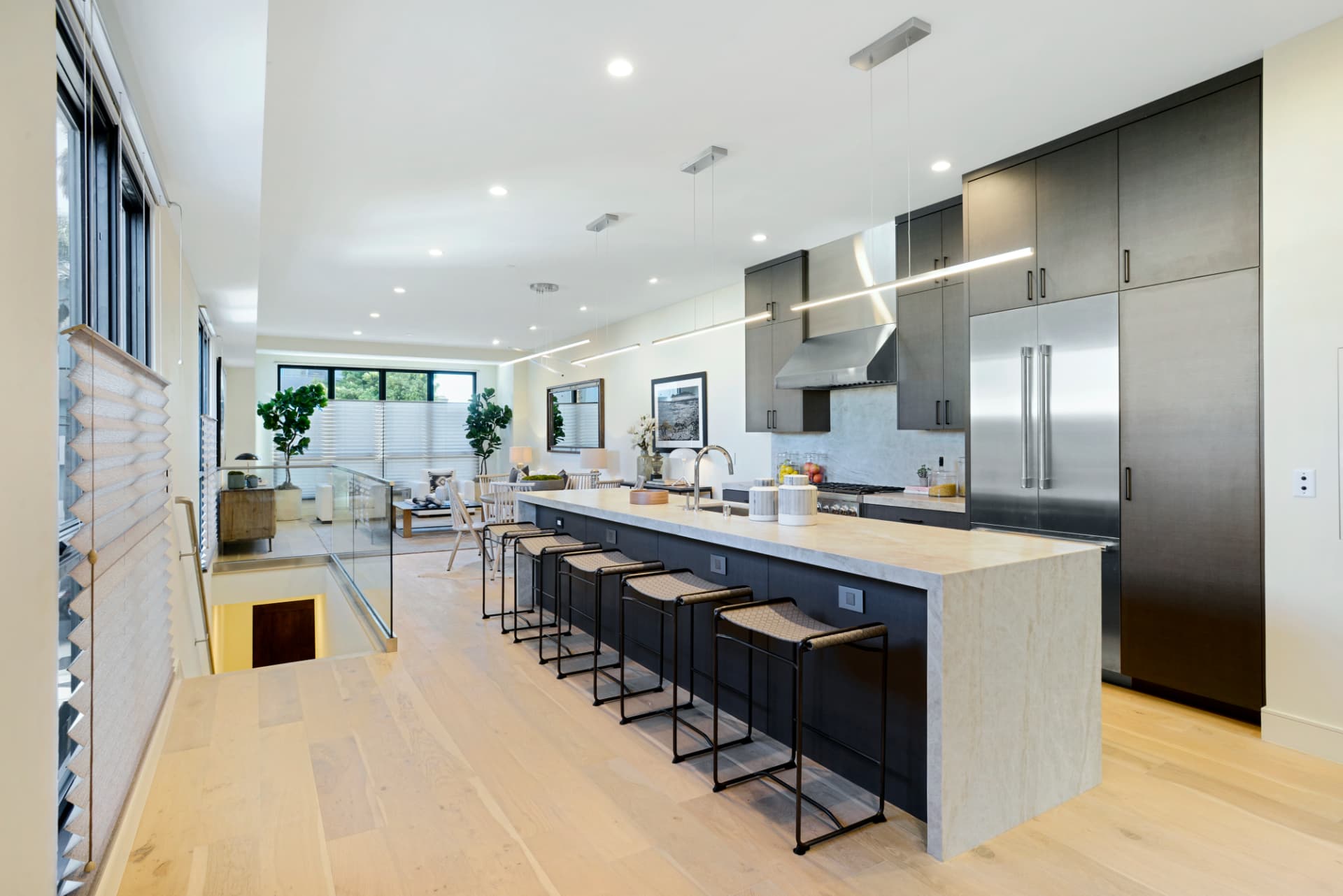 Los Angeles modern kitchen with waterfall island and stainless appliances