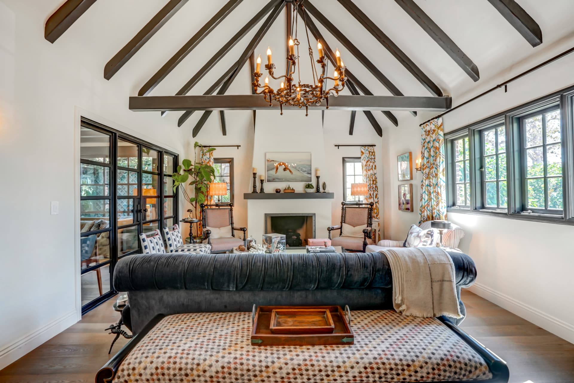 Hancock Park vaulted living room with iron chandelier and velvet sofa