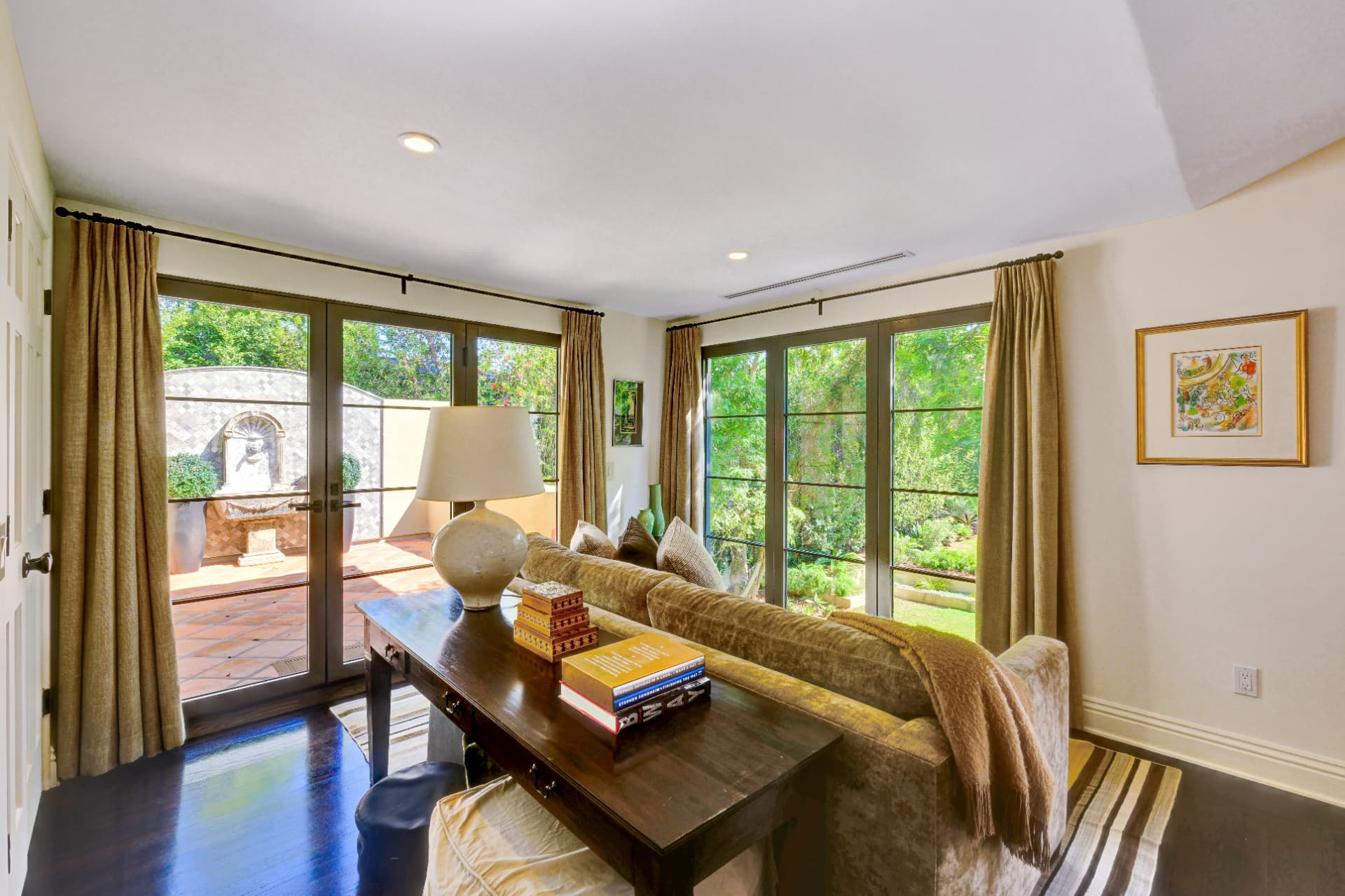 Hancock Park living room with French doors opening to a private garden patio