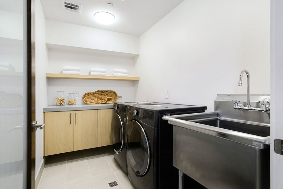 custom-contemporary-laundry-room-with-wood-vanity-and-free-standing-sink-in-los-angeles